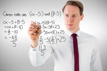 Composite image of businessman writing something with chalk 