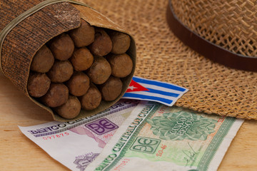 Siesta - cigars, straw hat and Cuban banknotes