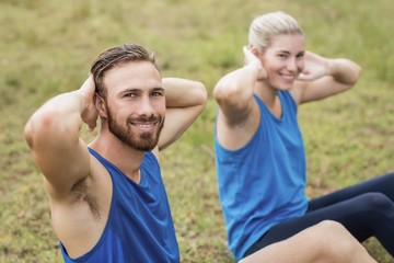 Fit people performing crunches exercise