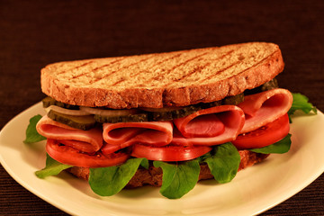 Sandwich with ham, tomatoes and cucumbers