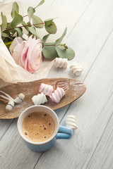 Bouquet, flower, cup of coffee, earphones.