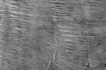 Texture of dark grey crumpled fabric