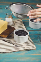 Chocolate homemade dark muffin on a blue wooden table