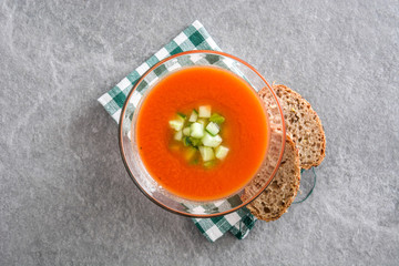 Traditional Spanish cold gazpacho soup on gray stone.
