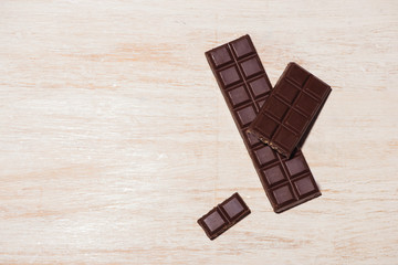 Chocolates bar in box on white wooden background