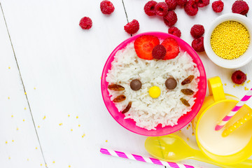 Milk rice porridge for kids healthy breakfast shaped cute kitty girl, creative idea for baby meal