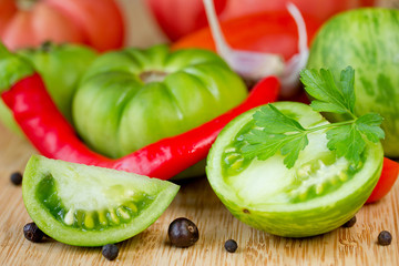 Fresh vegetables - green tomatoes, red hot chili pepper, garlic, parsley and spices