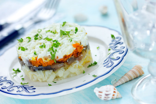 Layered salad with salted fish and vegetables