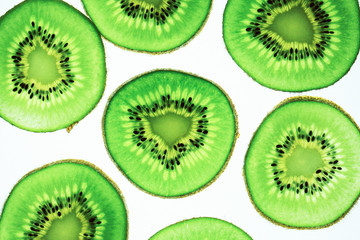 Fototapeta premium Still life picture, Abstract fruit background is close up on Kiwi sliced, to show a detail on fresh kiwi face with white background