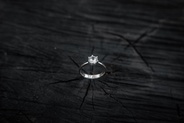 Engagement ring with a diamond on a black tree
