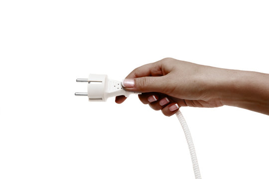 African female hand holds electric plug on a white background.