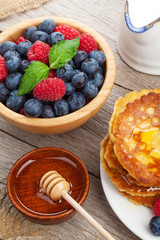 Pancakes with raspberry, blueberry, mint and honey syrup