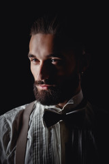 Portrait of handsome man posing for photographer in studio