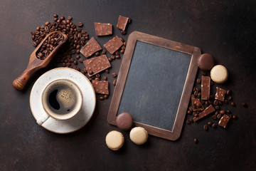 Coffee, chocolate and macaroons on old kitchen table