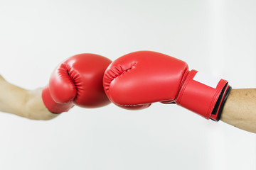 Fighter man punching with red boxing gloves. Boxing practicing.
