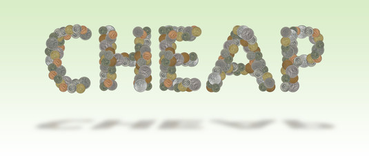 CHEAP – Coins on green background
