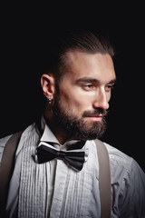 Portrait of handsome man posing for photographer in studio