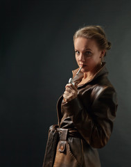 Portrait of young beautiful woman in brown leather coat