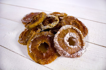 Apple candied fruits on white wooden serface
