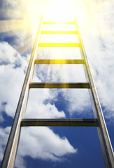 Ladder reaching into a blue sky and clouds