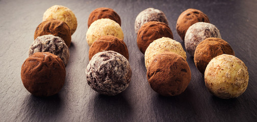 Chocolate truffle,Truffle chocolate candies with cocoa powder.Chocolate candies collection.Assorted chocolate truffles with cocoa powder, coconut and chopped hazelnuts on a dessert plate.