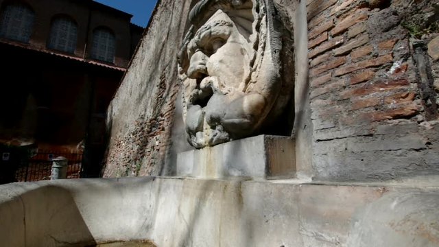 ROME, ITALY  Ancient Roman grotesque mask fountain in front of the church of Santa Sabina along Via di Santa Sabina on the Aventine Hill 