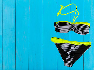 swimsuit on wooden background. top view