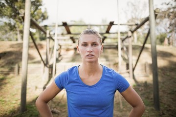 Portrait of fit woman standing with hands on hip 