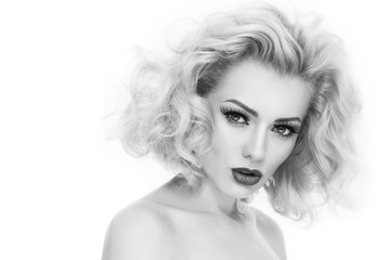 Black and white portrait of young beautiful woman with blond curly hair and false eyelashes