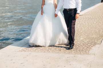 Fototapeta na wymiar Bride and groom holding hands. Wedding in Montenegro.