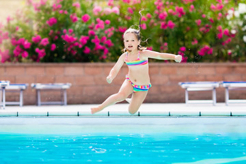 Child in swimming pool on summer vacation