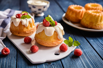 Mini lime bundt cakes with whipped cream and raspberries topping