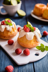 Mini lime bundt cakes with whipped cream and raspberries topping