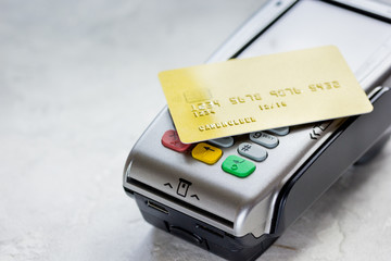 payment with credit card through terminal on stone background