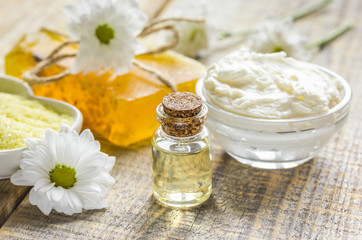close up body care camomile cosmetic products on wooden desk background