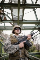 Military soldier guarding with a rifle