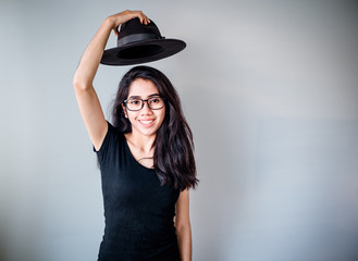 portrait of a beautiful young tender teenage girl and hipster asian woman model with Black hair posing in studio and showing different emotions . Laughing, smiling, anger, suspicion, fear, surprise.