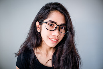 Fototapeta premium portrait of a beautiful young tender teenage girl and hipster asian woman model with Black hair posing in studio and showing different emotions . Laughing, smiling, anger, suspicion, fear, surprise.