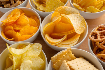 Pretzels in bowls on wooden table from above