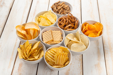 Pretzels in bowls on wooden table from above