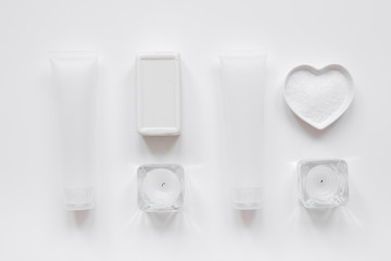 white bottles of body cream and lotion table background top view mock-up