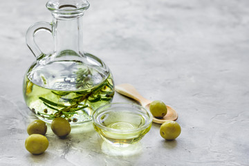 oil in carafe with spices and olive on stone background mock-up