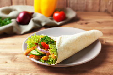 Plate with delicious kebab sandwich on wooden table