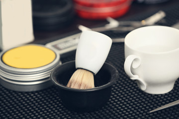 Obraz na płótnie Canvas Shaving brush and other tools in barbershop