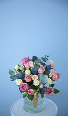 Glass vase with beautiful bouquet on color background