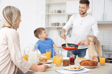 Fototapeta na wymiar Happy family having breakfast on kitchen
