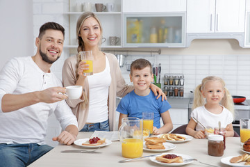 Happy family having breakfast on kitchen