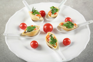 Plate with stuffed pasta on table