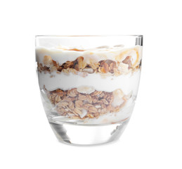 Tasty dessert with yogurt and granola in glass on white background