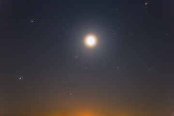 Fototapeta na wymiar orion constellation and full moon on a night sky
